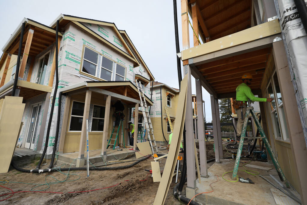 Construction crews work at the Windsor Veterans Village in Windsor on Tuesday, Feb. 9, 2021. The project includes 60 affordable housing units for low-income veterans and their families. (Christopher Chung / The Press Democrat)