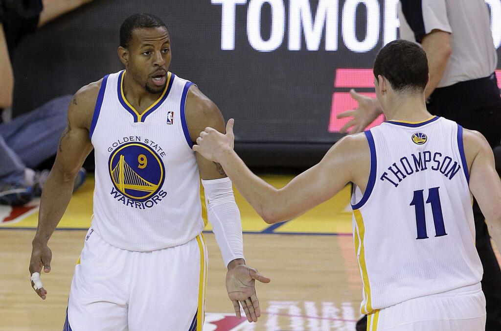 Golden State Warriors small forward Andre Iguodala (9) is congratulated by shooting guard Klay Thompson (11) after making a three-point basket against the Los Angeles Clippers during a 2014 game. The Warriors won 100-99. (AP Photo/Jeff Chiu)
