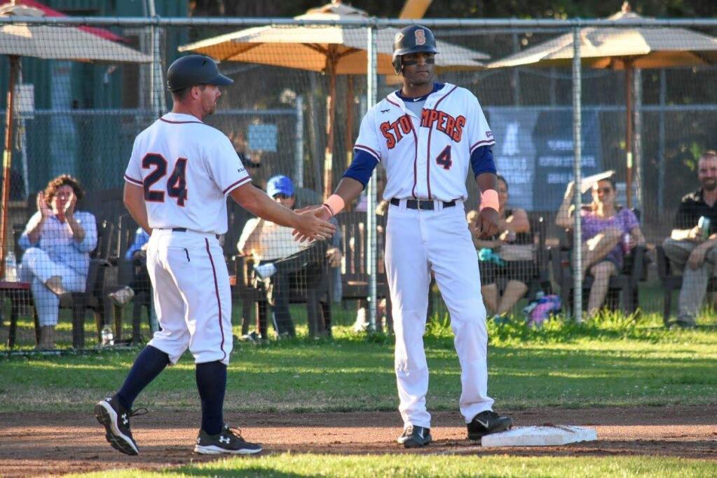 JAMES W. TOY III PHOTOSonoma Stompers manager Zack Pace, left, congratulates player Marcus Bradley, right. Pace was named Manager of the Year for the Pacific Association of Professional Baseball Clubs.