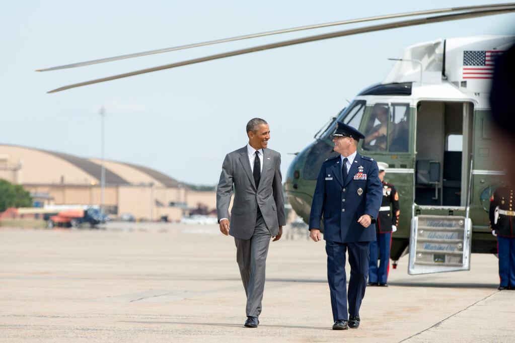 President Barack Obama walks from Marine One to Air Force One with Col. Lawrence Havird, 89th Maintenance Group commander, before traveling to New Orleans for the 10th anniversary since the devastation of Hurricane Katrina. (AP Photo/Andrew Harnik)