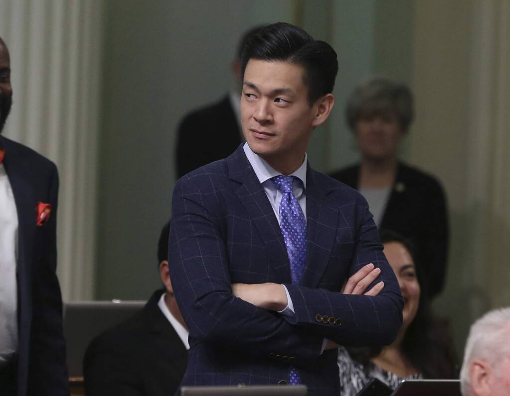 Assemblyman Evan Low, D-Campbell, watches the debate over a bill during the Assembly session Friday, Aug. 31, 2018, in Sacramento, Calif. Low announced Friday that he is ending his effort this year to pass a bill declaring gay conversion therapy a fraudulent practice. (AP Photo/Rich Pedroncelli)