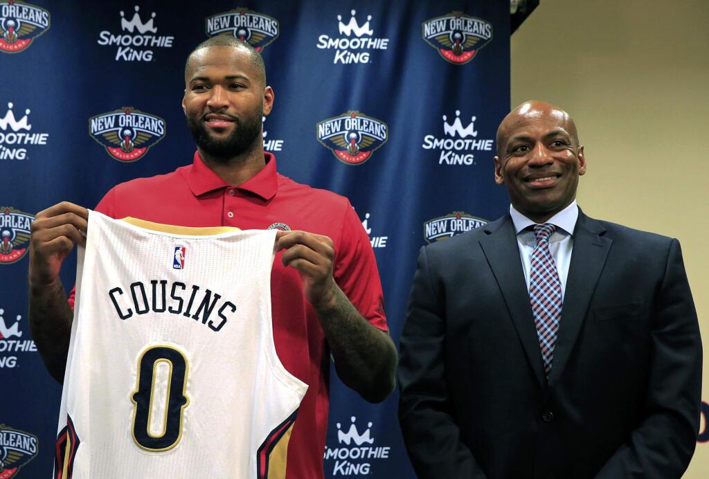DeMarcus Cousins holds his new jersey '0' with New Orleans Pelicans general manager Dell Demps during a news conference on Wednesday, Feb. 22, 2017 in Metairie, La. Cousins maintained that he liked Sacramento and initially wasn't happy about being traded Sunday night, but added he'd become frustrated with the lack of another elite talent on the Kings' roster. (Ted Jackson /NOLA.com The Times-Picayune via AP)