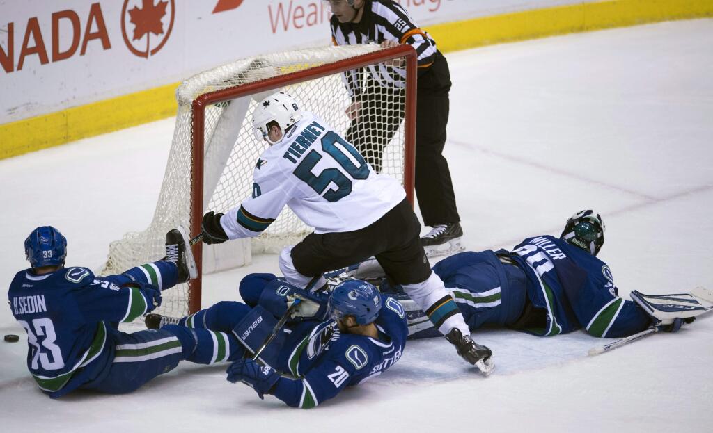 San Jose Sharks center Chris Tierney fails to get a shot past Vancouver Canucks goalie Ryan Miller (30) as Canucks center Henrik Sedin (33) and center Brandon Sutter (20) watch during the second period Saturday, Feb. 25, 2017, in Vancouver, British Columbia. (Jonathan Hayward/The Canadian Press via AP)