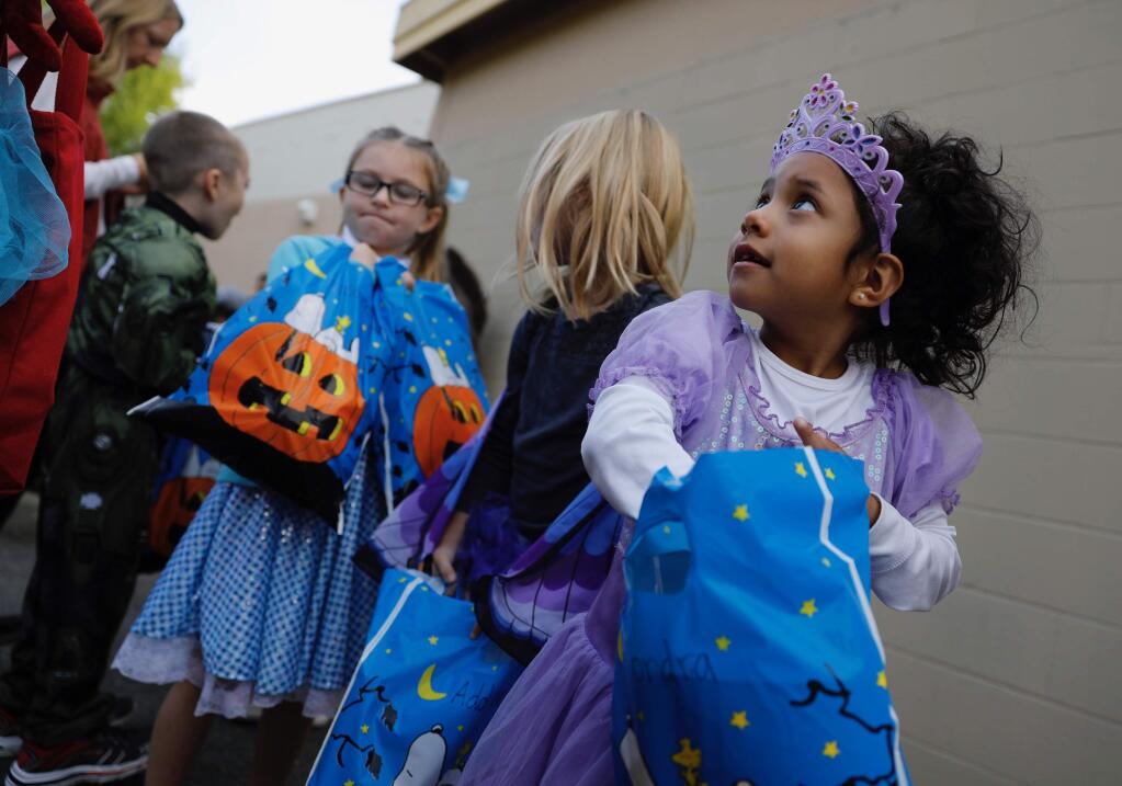Kindergartners line up for Halloween treats at the district office at Valley Vista Elementary School in Petaluma, Tuesday, Oct. 31, 2017. (Beth Schlanker / Press Democrat)