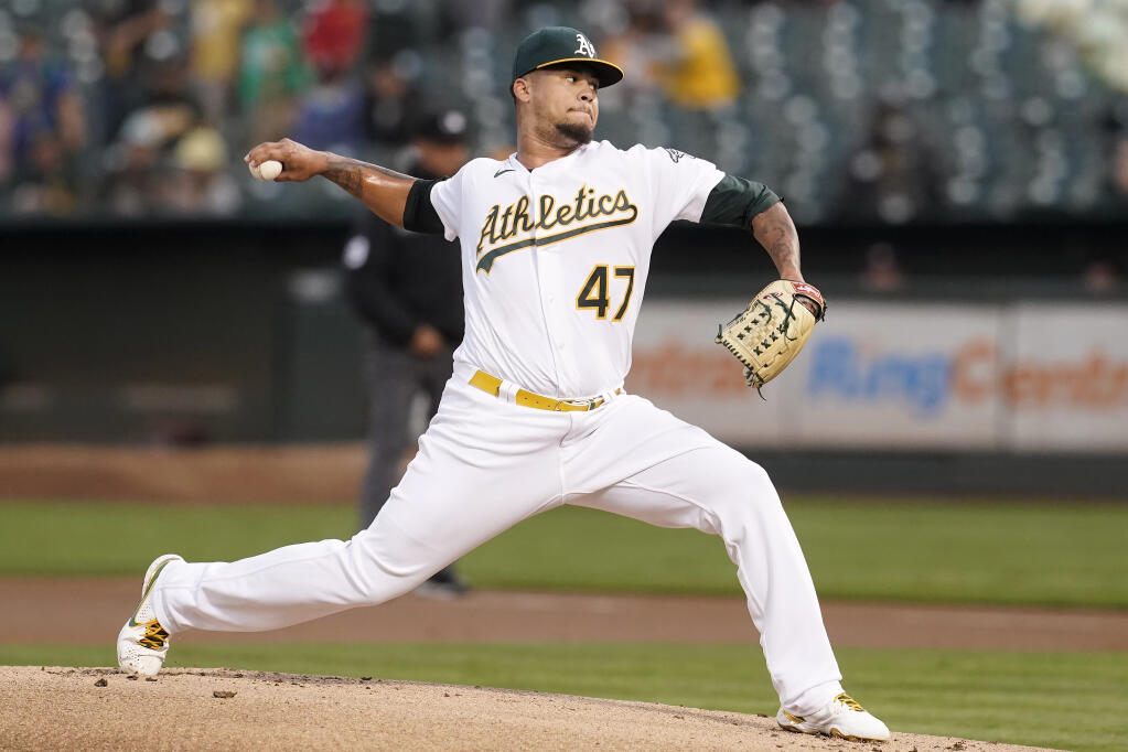 The Oakland Athletics’ Frankie Montas pitches against the Houston Astros during the first inning in Oakland on Friday, Sept. 24, 2021. (Jeff Chiu / ASSOCIATED PRESS)