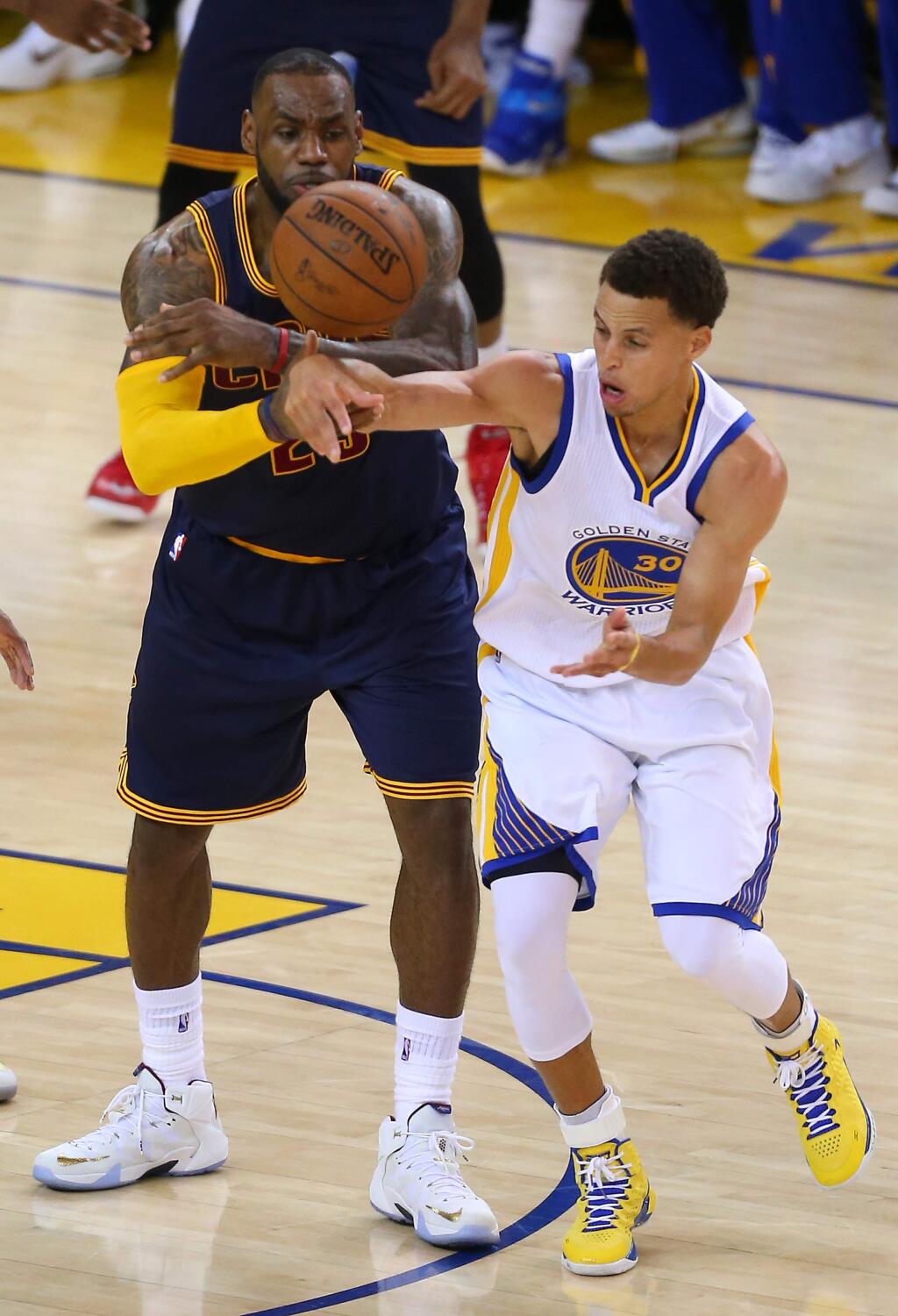 Golden State Warriors guard Stephen Curry steals the ball from Cleveland Cavaliers forward LeBron James late in the fourth quarter during Game 1 of the NBA Finals at Oracle Arena, in Oakland on Thursday, June 4, 2015. The Warriors defeated the Cavaliers 108-100 in overtime.(Christopher Chung/ The Press Democrat)