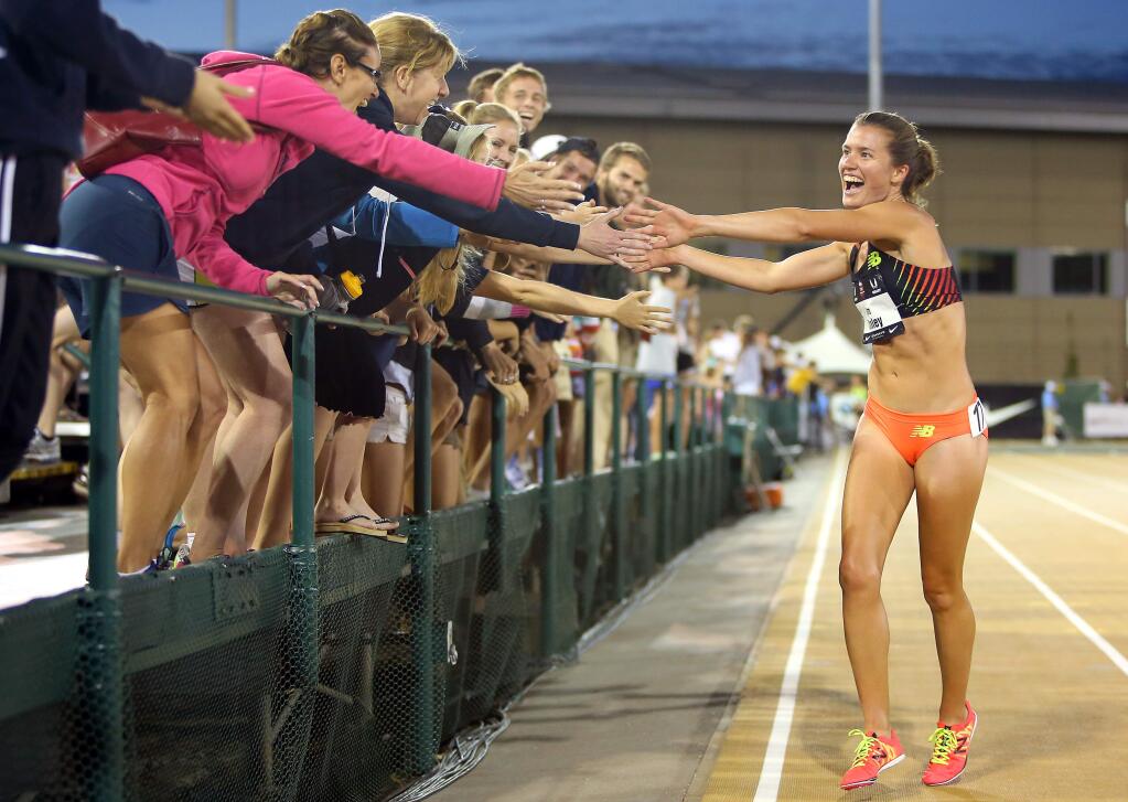 Kim Conley takes her victory lap after winning the 10,000 meter race, during the USA Track and Field Outdoor Championships, in Sacramento on Thursday, June 26, 2014. (Christopher Chung/ The Press Democrat)