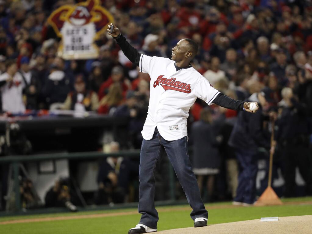 Former Cleveland Indians outfielder Kenny Lofton throws the ceremonial first pitch before Game 1 of the Major League Baseball World Series against the Chicago Cubs Tuesday, Oct. 25, 2016, in Cleveland. (AP Photo/David J. Phillip)