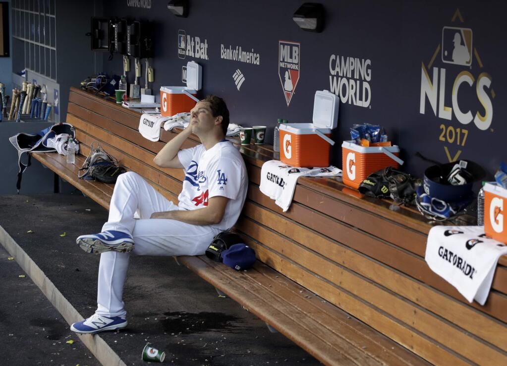 Los Angeles Dodgers starting pitcher Rich Hill sits in the dugout during the third inning of Game 2 of baseball's National League Championship Series against the Chicago Cubs in Los Angeles, Sunday, Oct. 15, 2017. (AP Photo/Matt Slocum)