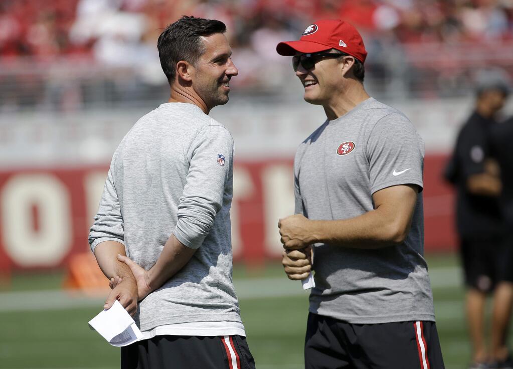 San Francisco 49ers head coach Kyle Shanahan, left, laughs with general manager John Lynch during training camp in Santa Clara, Saturday, Aug. 5, 2017. (AP Photo/Jeff Chiu)
