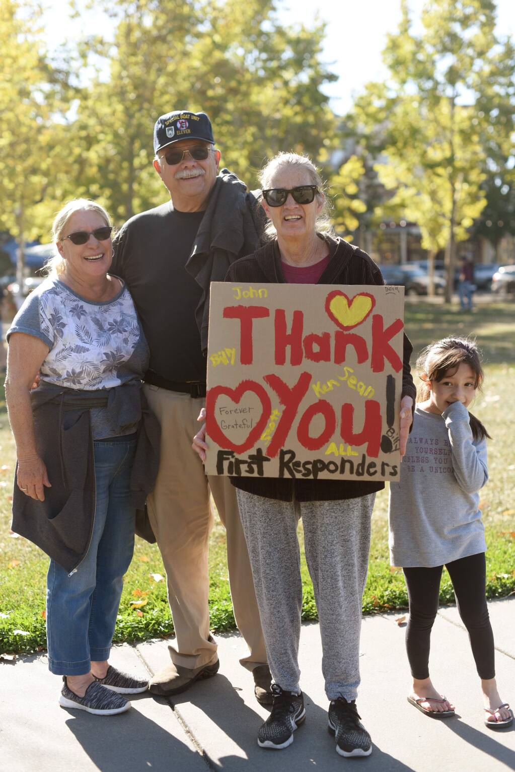 From left, Valerie and Charles Witherell, Betsy Allen and Jasmine Allen, 6, came with other local residents to personally thank first responders for saving the town from the Kincade Fire on Nov. 3, 2019. (Erik Castro/ for The Press Democrat)