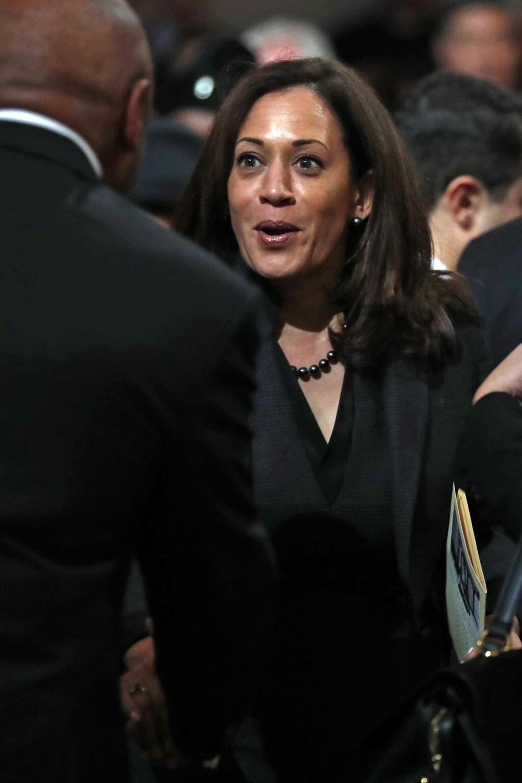 Sen. Kamala Harris, right, greets former San Francisco Mayor Willie Brown after a service celebrating the life of Mayor Ed Lee at San Francisco City Hall in San Francisco, Sunday, Dec. 17, 2017. San Francisco Mayor Ed Lee was remembered for his humility, integrity and infectious smile during a public celebration of his life Sunday at City Hall attended by family members, former staff, politicians and residents. (Scott Strazzante/San Francisco Chronicle via AP, Pool)