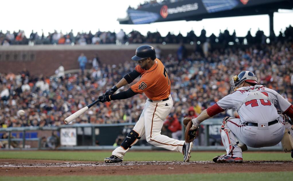 San Francisco Giants' Gregor Blanco, left, drives in a run with a single against the Washington Nationals during the second inning Friday, July 29, 2016, in San Francisco. (AP Photo/Marcio Jose Sanchez)