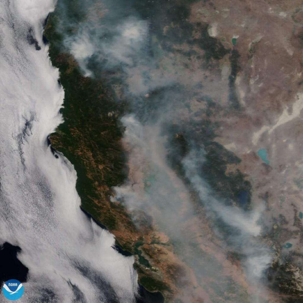 This satellite image released on Tuesday, Aug. 7, 2018 provided by NOAA shows the wildfires known as the Mendocino Complex, Calif. Northern California is grappling with the largest wildfire in California history, breaking a record set only months earlier. Experts say this may become the new normal as climate change coupled with the expansion of homes into undeveloped areas creates more intense and devastating blazes. (NOAA via AP)