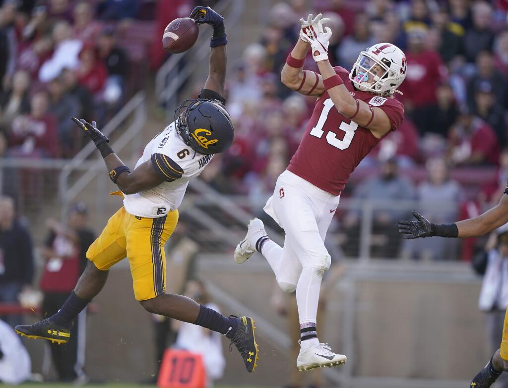 Cal safety Jaylinn Hawkins (6) intercepts a pass for Stanford wide receiver Simi Fehoko (13) during the second half Saturday, Nov. 23, 2019 in Stanford. (AP Photo/Tony Avelar)