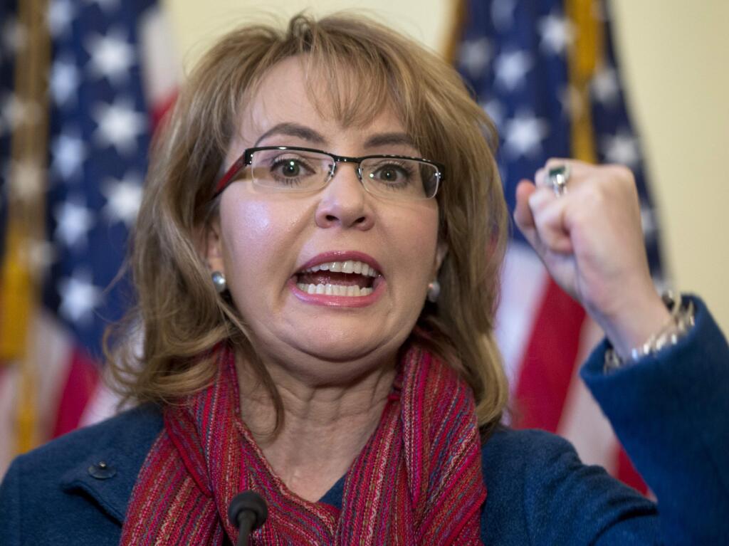 Former Arizona Rep. Gabby Giffords, D-Ariz. gestures as she speaks on Capitol Hill in Washington, Wednesday, March 4, 2015, about bipartisan legislation on gun safety. Giffords returned to Capitol Hill to join forces with advocates of expanded criminal background checks on all commercial firearms sales. The measure is considered a longshot because of opposition by the National Rifle Association. Giffords was shot in the head during a 2011 rampage in Arizona that left six people dead and a dozen others wounded. (AP Photo/Carolyn Kaster)