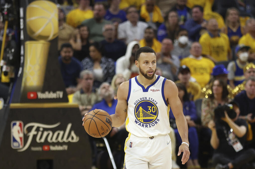 Warriors guard Stephen Curry brings the ball up the court against the Boston Celtics during the first half of Game 5 of the NBA Finals in San Francisco on Monday, June 13, 2022. (AP Photo/Jed Jacobsohn)
