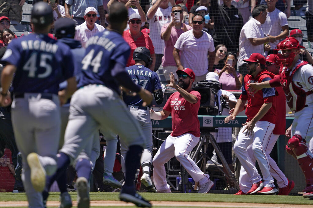 Seattle Mariners' Jesse Winker, center left, fights with Los Angeles Angels Anthony Rendon, center, right, after he was hit by a pitch and went after players in the Angels dugout during the second inning of a baseball game Sunday, June 26, 2022, in Anaheim, Calif. (AP Photo/Mark J. Terrill)