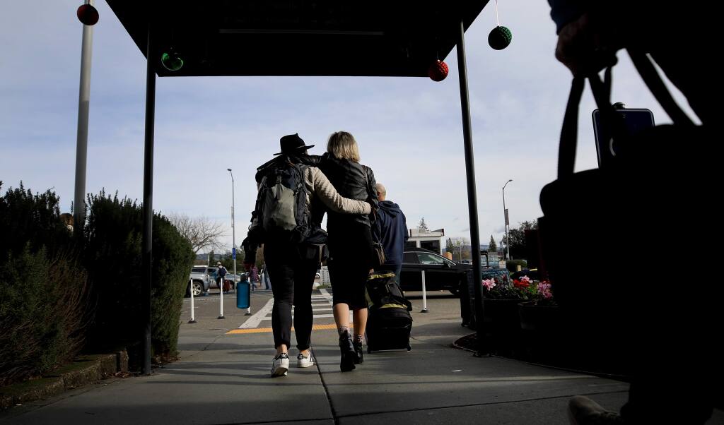 Passengers leave the Charles M. Schulz-Sonoma County Airport terminal in Santa Rosa on Tuesday, Dec. 24, 2019. (KENT PORTER/ PD)