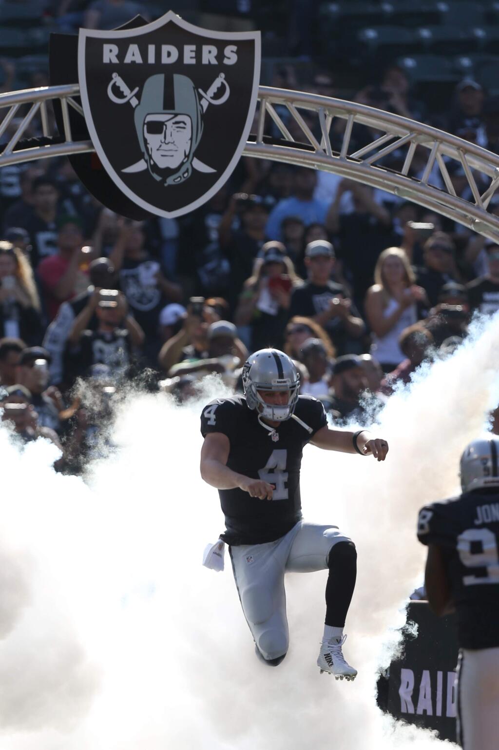 Oakland Raiders quarterback Derek Carr is introduced to the crowd before the game against the Tennessee Titans in Oakland on Saturday, August 27, 2016. (Christopher Chung/ The Press Democrat)
