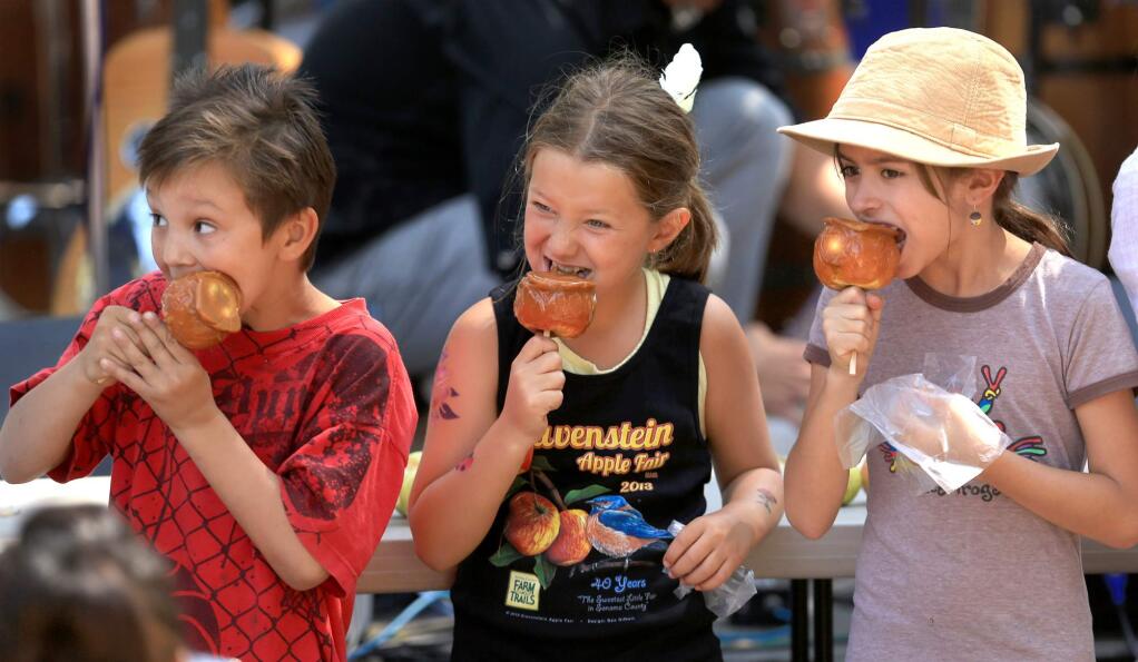 Children compete in the caramel-apple-eating contest at the Gravenstein Apple Fair in Sebastopol in 2012. (KENT PORTER/ PD FILE)