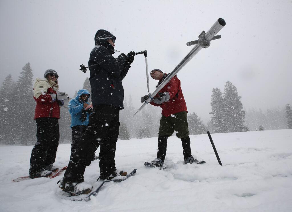 Frank Gehrke, right, chief of the California Cooperative Snow Surveys Program for the Department of Water Resources, places the snow survey tube on a scale held by Nic Enstice, of the Sierra Nevada Conservancy while doing the manual snow survey at Phillips Station, Thursday, March 30, 2017, near Echo Summit, Calif. The survey found the snowpack's water content at 183 at percent of normal for this location at this time of year. Overall, the state's electronic snow monitors show the Sierra Nevada snowpack at 164 percent of normal. (AP Photo/Rich Pedroncelli)