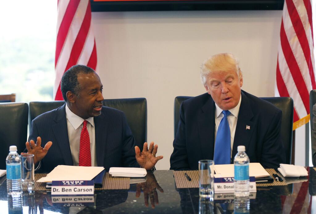 FILE - In this Aug. 25, 2016 photo, former Republican presidential candidate Dr. Ben Carson during Republican presidential candidate Donald Trump's roundtable meeting with the Republican Leadership Initiative in his offices at Trump Tower in New York. Trump has chosen former Campaign 2016 rival Ben Carson to become secretary of the Department of Housing and Urban Development. (AP Photo/Gerald Herbert)