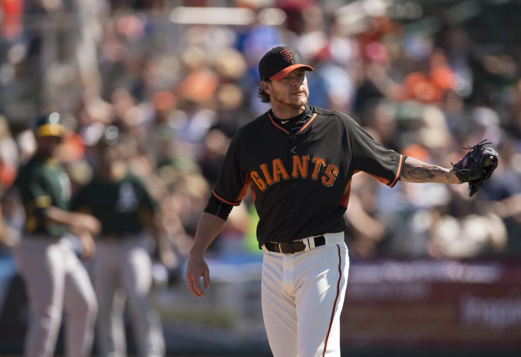 San Francisco Giants starting pitcher Jake Peavy reacts after throwing a pitch for a ball during the first inning against the Oakland Athletics in a spring training baseball game Wednesday, March 4, 2015, in Scottsdale, Ariz. (AP Photo/The Sacramento Bee, Jose Luis Villegas)