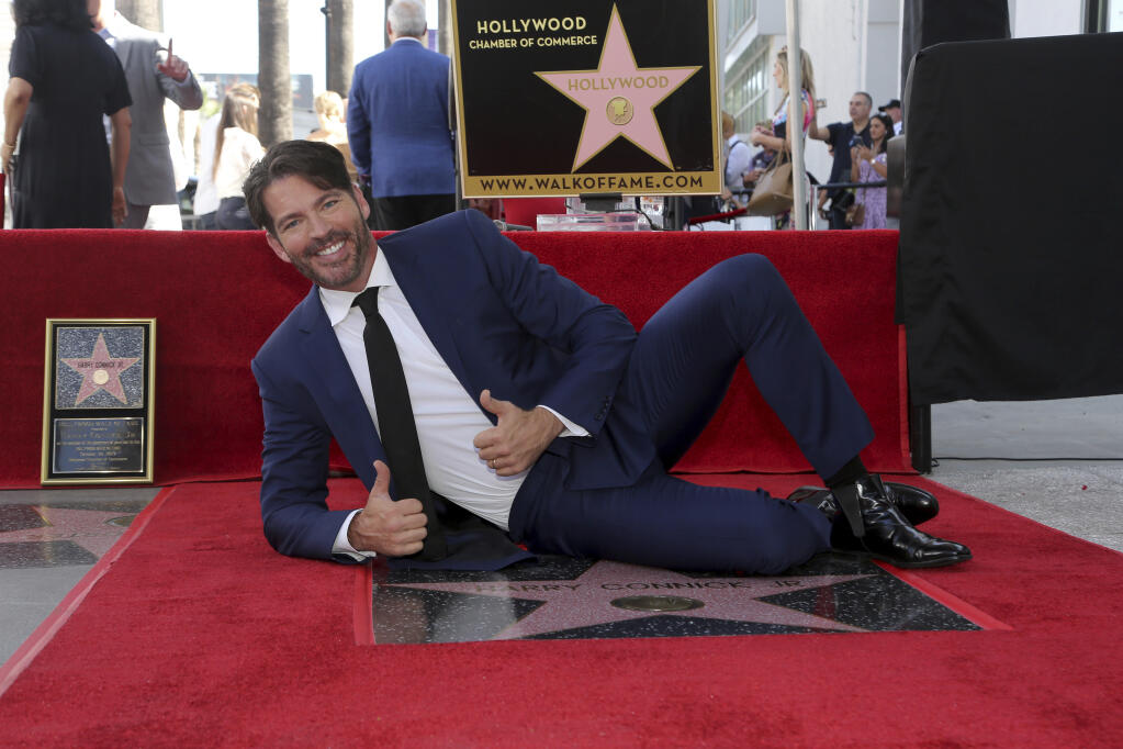 Harry Connick Jr. poses atop his star during a ceremony honoring him with a star at the Hollywood Walk of Fame on Thursday, Oct. 24, 2019, in Los Angeles. (Photo by Willy Sanjuan/Invision/AP)
