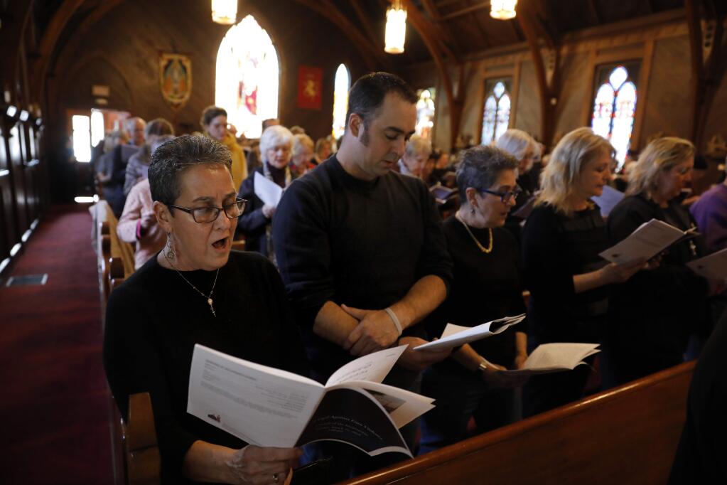 Mary Kennaugh, director of the Alleluia Choir, and her son Chris, sing during A Vigil Against Gun Violence service at Church of the Incarnation in Santa Rosa on Sunday, March 24, 2019. (BETH SCHLANKER/ The Press Democrat)