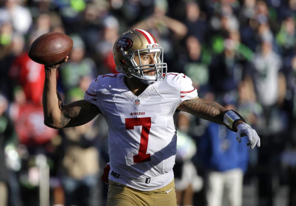 San Francisco 49ers quarterback Colin Kaepernick passes in the first half of an NFL football game against the Seattle Seahawks, Sunday, Dec. 14, 2014, in Seattle. (AP Photo/Elaine Thompson)