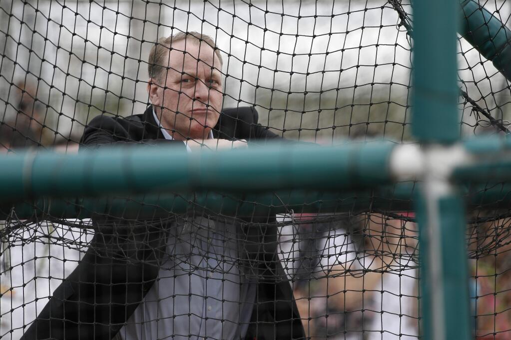 Baseball analyst and former Boston Red Sox pitcher Curt Schilling watches as infielders take batting practice at baseball spring training in Fort Myers Fla., Wednesday Feb. 25, 2015. (AP Photo/Tony Gutierrez)