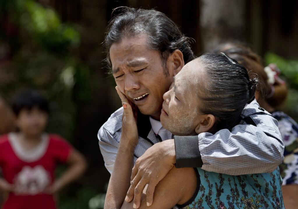 In this May 16, 2015 photo, former slave fisherman Myint Naing and his mother, Khin Than, cry as they are reunited after 22 years at their village in Mon State, Myanmar. Myint, 40, is among hundreds of former slave fishermen who returned to Myanmar following an Associated Press investigation into the use of forced labor in Southeast Asia's seafood industry. (AP Photo/Gemunu Amarasinghe)
