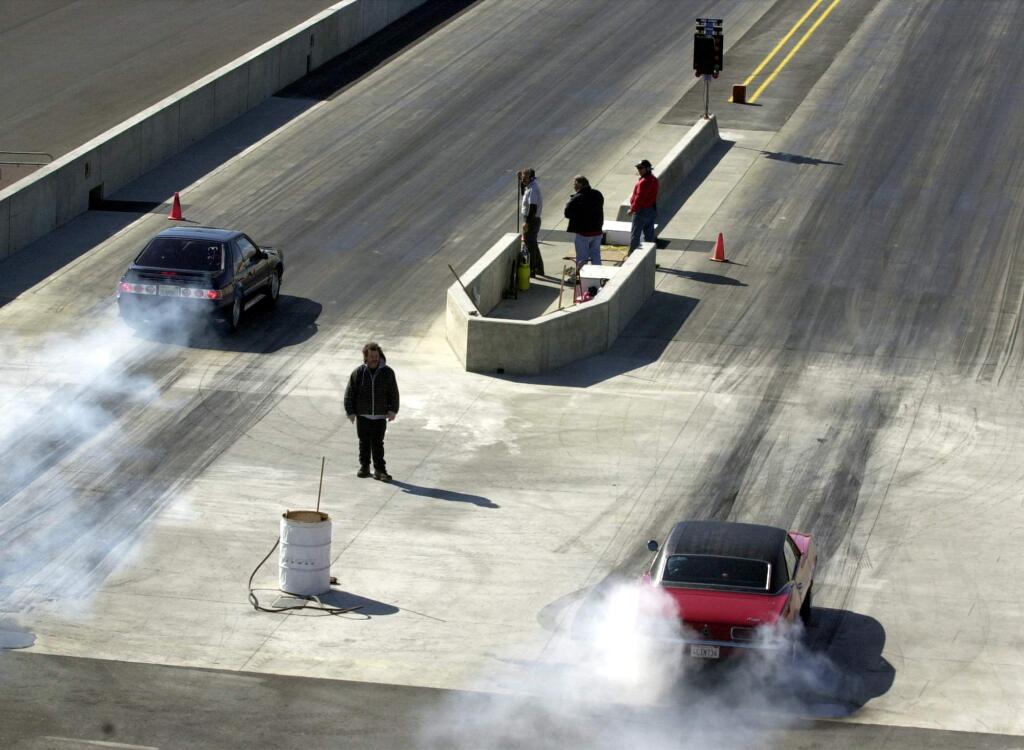 Cars burn out prior to the start of a race during Wednesday Night Drags at Sears Point Raceway.