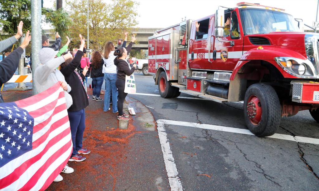 Hundreds of Sonoma County residents came out with signs, banners, balloons and flags to show their appreciation to firefighters and first responders. (WILL BUCQUOY / For The Press Democrat, 2017)