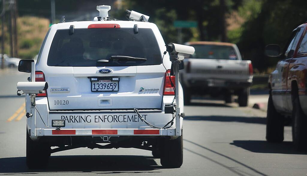 Larry Tait, the parking enforcement supervisor for Santa Rosa, maneuvers his camera-laden vehicle near the Sonoma County Fairgrounds on Tuesday, July 11, 2017. (KENT PORTER/ PD)