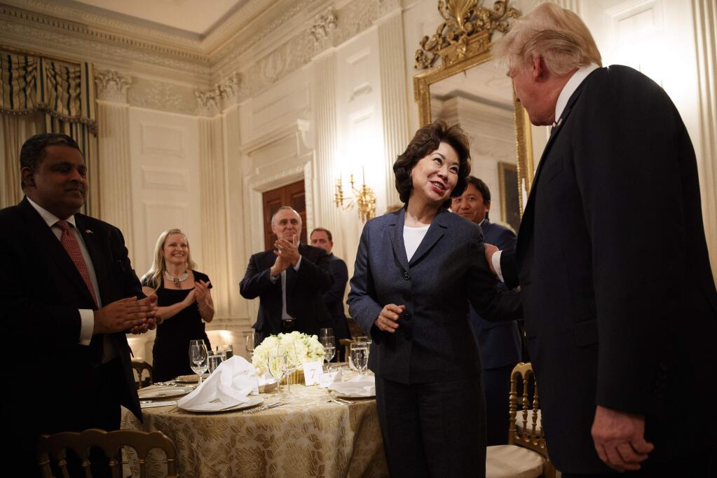FILE -- Transportation Secretary Elaine Chao with President Donald Trump at the White House in Washington, June 6, 2018. Energy giants and conservative groups have been aggressively pushing Trump's rollback of fuel efficiency rules for automobiles, a Times investigation found. (Tom Brenner/The New York Times)