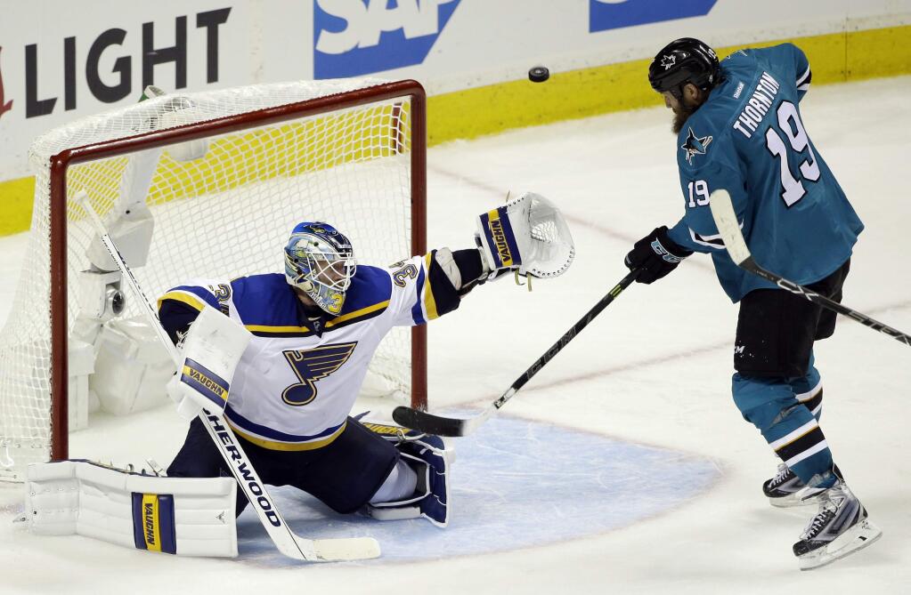 St. Louis Blues goalie Jake Allen (34) deflects a shot next to San Jose Sharks' Joe Thornton (19) during the third period in Game 4 of the NHL hockey Stanley Cup Western Conference finals Saturday, May 21, 2016, in San Jose, Calif. St. Louis won 6-3. (AP Photo/Marcio Jose Sanchez)