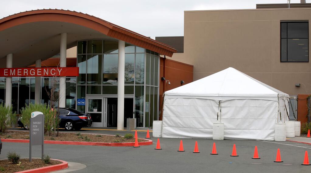A surge tent is in the process of being outfitted to help identify those with cold, flu and coronavirus symptoms at Sutter Santa Rosa Regional Hospital, Thursday, March 5, 2020. The first Sonoma County death from coronavirus came at this hospital, on March 20. (Kent Porter / The Press Democrat) 2020