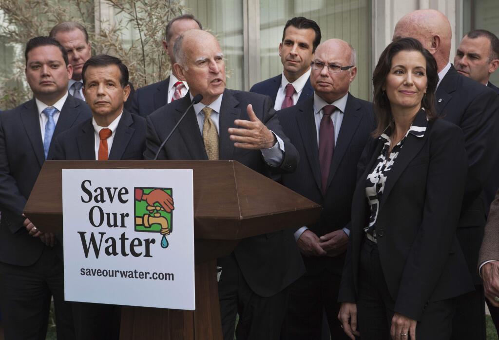 Gov. Jerry Brown talks during a news conference after meeting with several California mayors to discuss water conservation at the Capitol in Sacramento, Calif., on Tuesday, April 28, 2015. Gov. Brown called for $10.000 fines for residents and businesses that waste the most water as California cities try to meet mandatory conservation targets during the drought. (AP Photo/Steve Yeater)