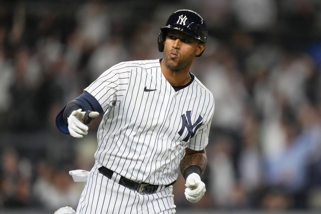 New York Yankees' Aaron Hicks gestures to teammates as he runs the bases after hitting a two-run home run during the seventh inning of a baseball game against the Oakland Athletics, Monday, May 8, 2023, in New York. (AP Photo/Frank Franklin II)