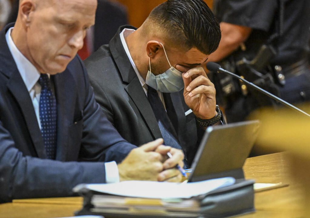 Lee Kindlon, attorney for Nauman Hussain, left, and Nauman Hussain, who ran the limo company involved in the 2018 crash in Schoharie that killed 20 people, listens to a victim impact statement during a proceeding in Schoharie County court on Wednesday, Aug. 31, 2021, in Schoharie, N.Y.