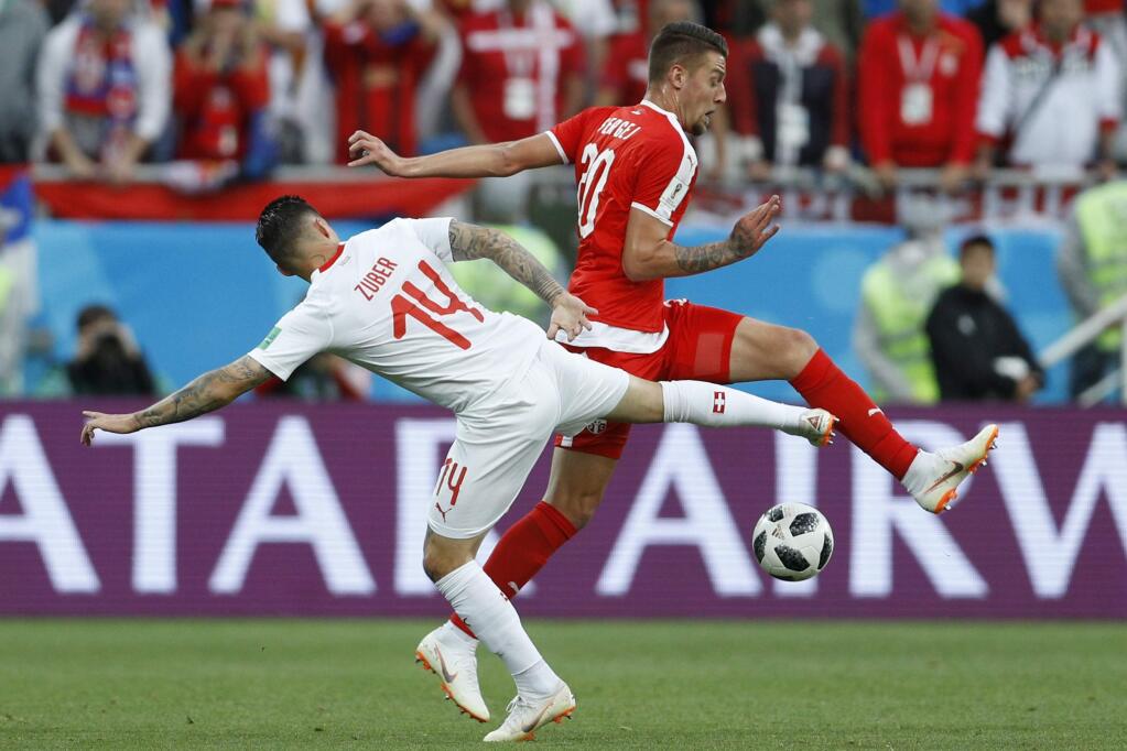 Switzerland's Steven Zuber and Serbia's Sergej Milinkovic-Savic battle for the ball a World Cup match Friday in Kaliningrad, Russia. (VICTOR CAIVANO / Associated Press)