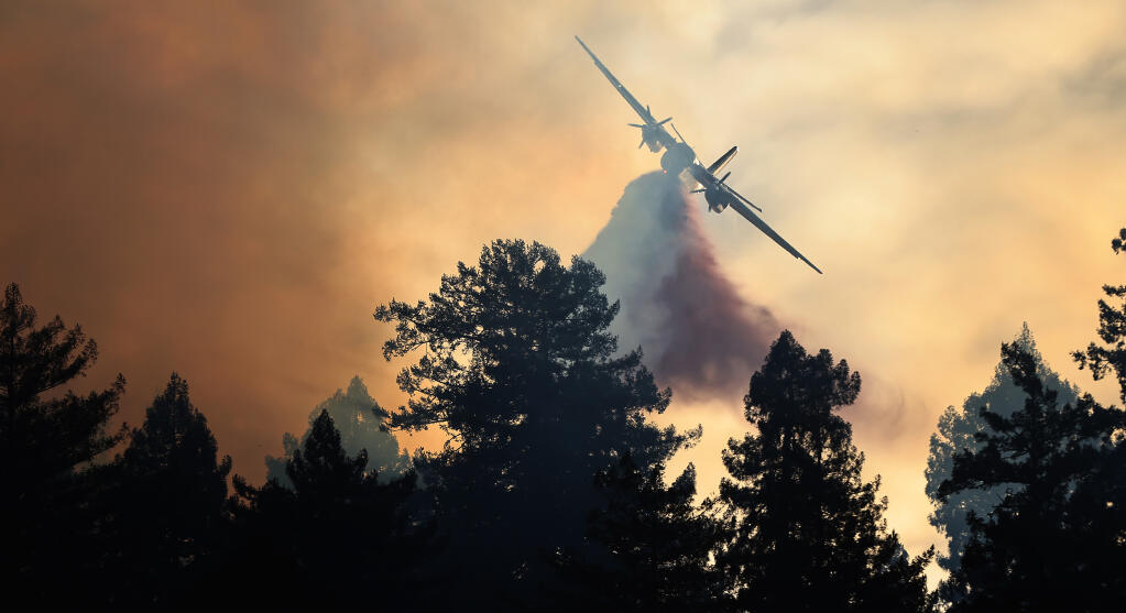 A Cal Fire air tanker makes a drop on the Alpine fire above Monte Rio, Tuesday, March 1, 2022. (Kent Porter / The Press Democrat)