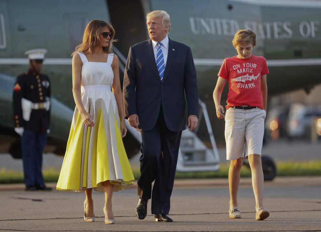 FILE - In this Aug. 20, 2017 file photo, President Donald Trump, first lady Melania Trump and son Barron Trump walk across the tarmac before boarding Air Force One at Morristown Municipal Airport in Morristown, N.J., for the return flight to the Washington. The White House is appealing to the news media for privacy for President Donald Trump's young son, Barron. (AP Photo/Pablo Martinez Monsivais, File)