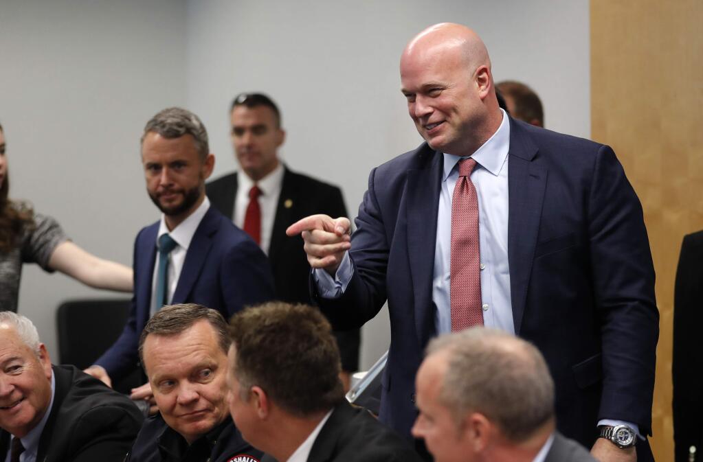 Acting Attorney General Matthew Whitaker, right, greets state and local law enforcement officials at the U.S. Attorney's Office for the Southern District of Iowa, Wednesday, Nov. 14, 2018, in Des Moines, Iowa. (AP Photo/Charlie Neibergall)