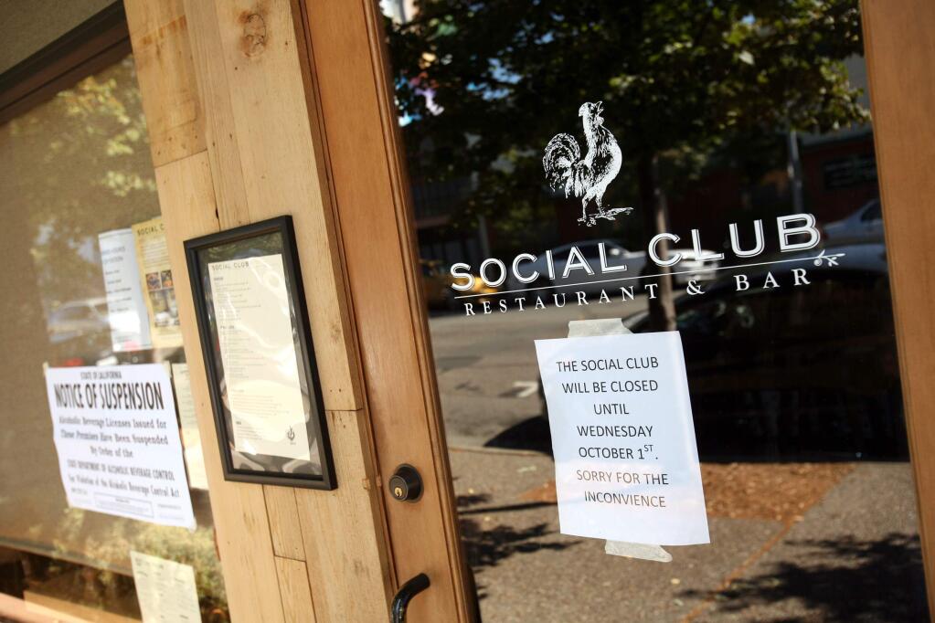 Signs on the front of the Social club Restaurant & Bar on Keller Street on Tuesday, September 30, 2014 by the State of California and also the restaurant owners say little about why the restaurant has been closed since Sept. 25, 2014.. (SCOTT MANCHESTER/ARGUS-COURIER STAFF)