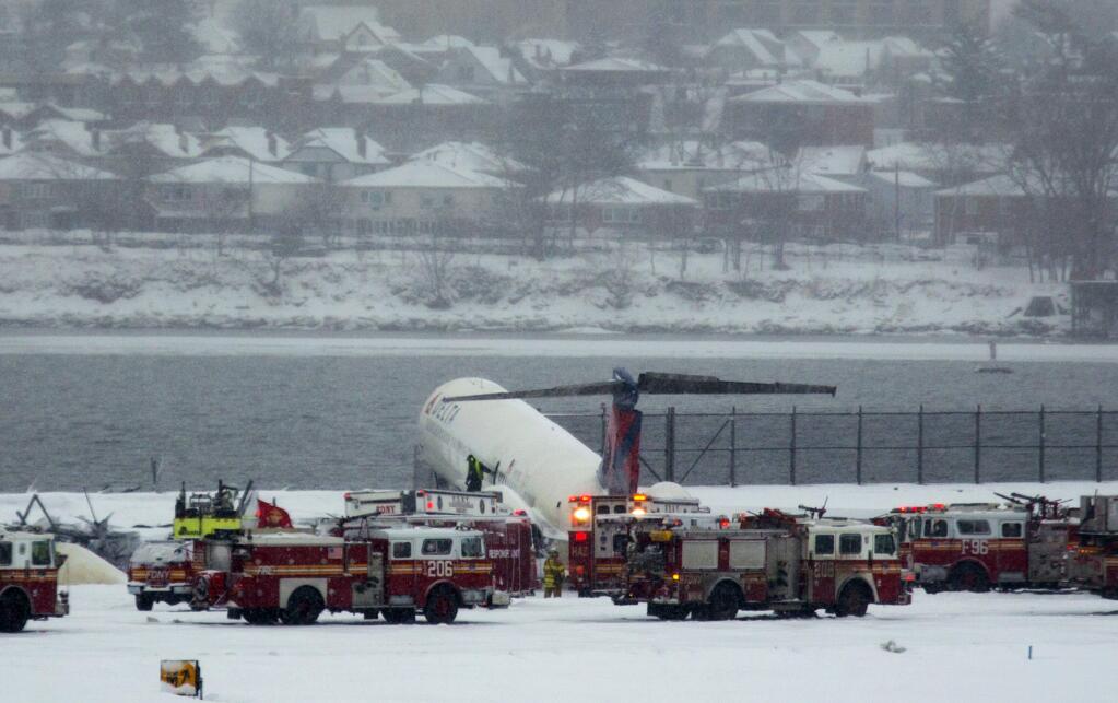A Delta plane rests on a berm near the water at LaGuardia Airport in New York, Thursday, March 5, 2015. Delta Flight 1086, carrying 125 passengers and five crew members, veered off the runway at around 11:10 a.m., authorities said. Six people suffered non-life-threatening injuries, said Joe Pentangelo, a spokesman for the Port Authority of New York and New Jersey, which runs the airport. (AP Photo/Craig Ruttle)