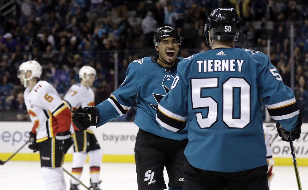 San Jose Sharks' Evander Kane, center, celebrates his goal with teammate Chris Tierney (50) during the second period against the Calgary Flames Saturday, March 24, 2018, in San Jose. (AP Photo/Marcio Jose Sanchez)