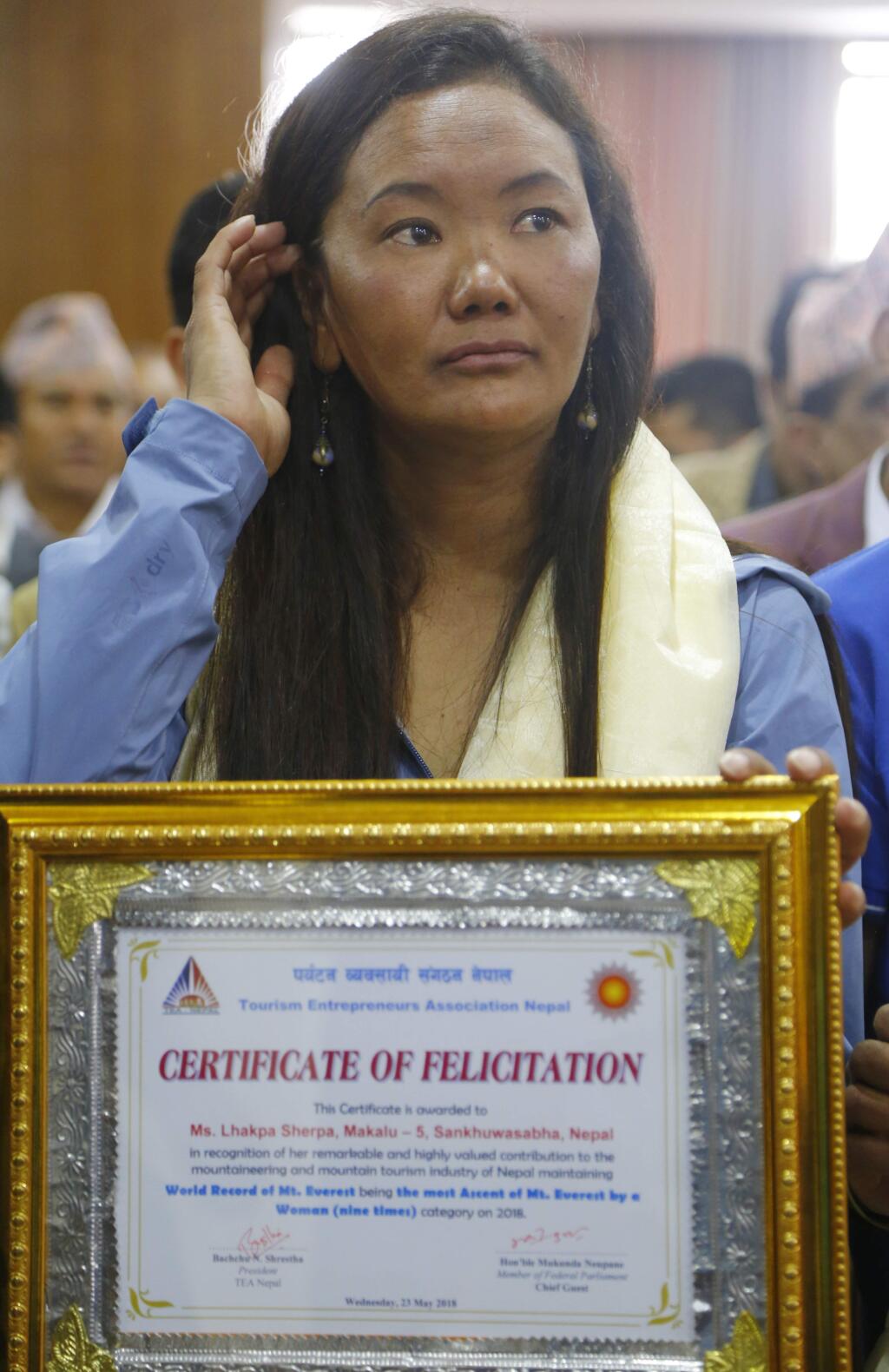 Nepalese woman climber Lhakpa Sherpa holds an honorary certificate in Kathmandu, Nepal, Wednesday, May 23, 2018. Lhakpa Sherpa scaled the 8,850-meter (29,035-foot) peak last week, breaking her own record for the most climbs by a woman. (AP Photo/Niranjan Shrestha)